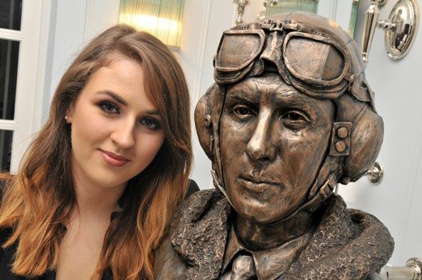 Sculptor Jenna Gearing with bust of an unnamed aviator